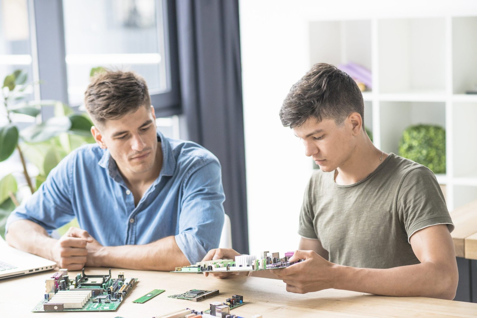 colleague-looking-it-engineer-repairing-pc-motherboard colleague-looking-it-engineer-repairing-pc-motherboard